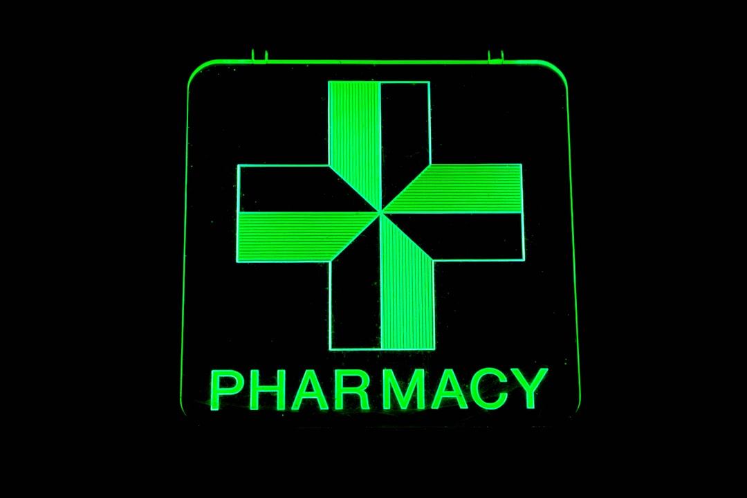a-green-pharmacy-sign-with-a-cross-on-it-mr0lrkp5myw